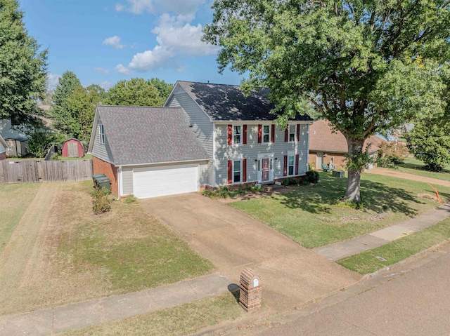 colonial-style house with a garage and a front lawn