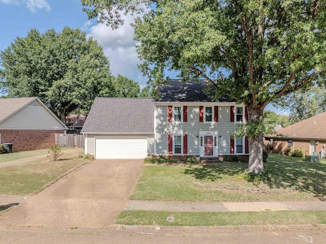 colonial house featuring a garage and a front yard