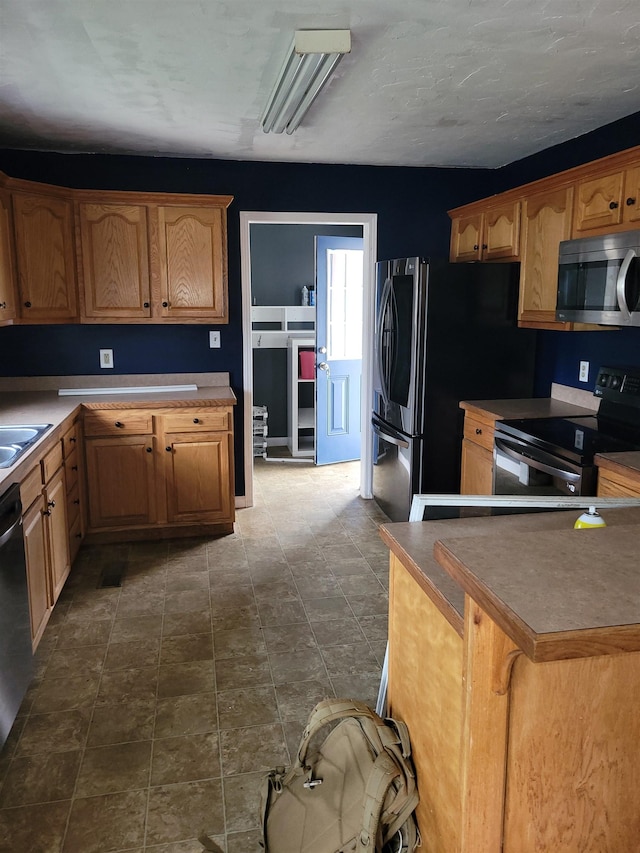 kitchen with sink, black appliances, and a kitchen breakfast bar