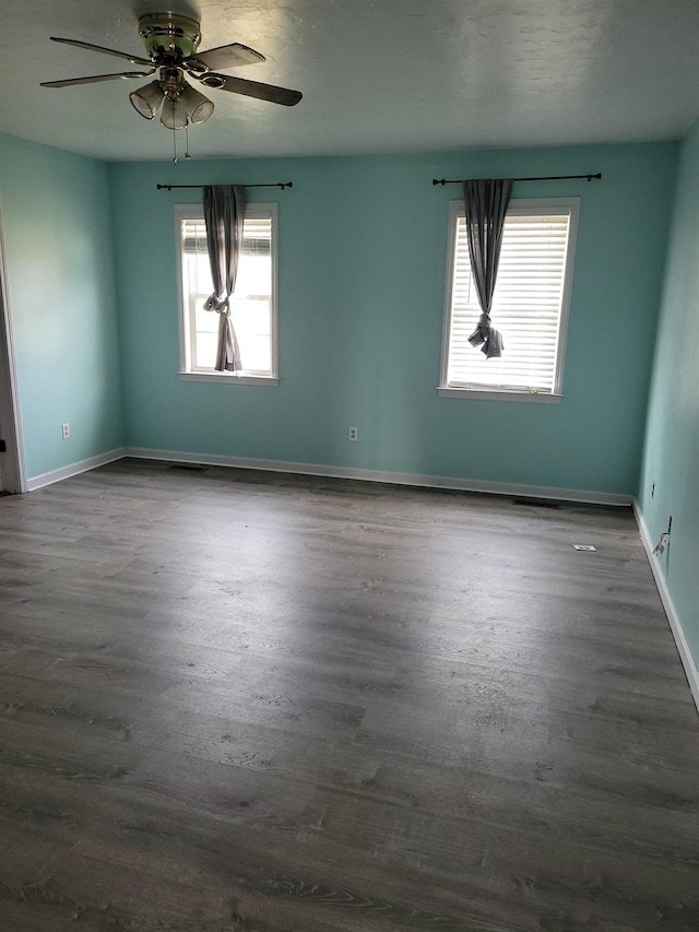 spare room featuring ceiling fan and dark hardwood / wood-style flooring