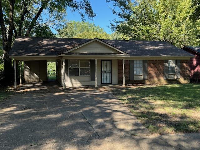 ranch-style home with a carport and a porch