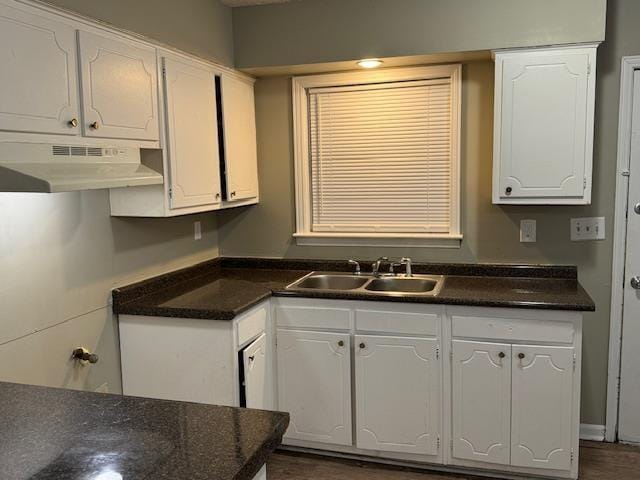 3245 Sinclair Dr, Memphis, TN 38127 - kitchen featuring under cabinet range hood, white cabinetry, dark countertops, and dark wood-style floors