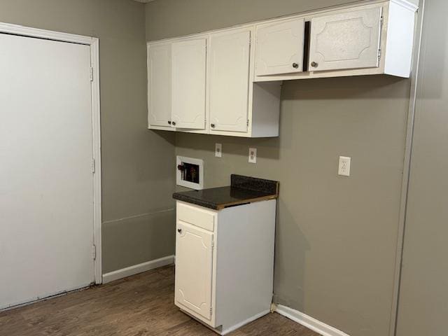 3245 Sinclair Dr, Memphis, TN 38127 - kitchen with dark countertops, dark wood-style floors, and white cabinetry