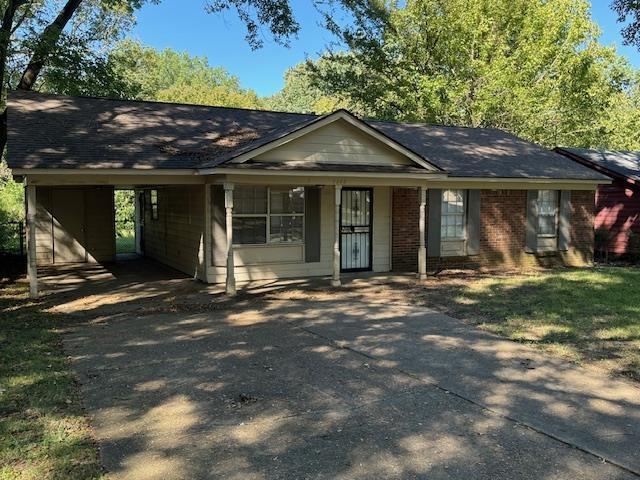3245 Sinclair Dr, Memphis, TN 38127 - single story home with a carport, roof with shingles, driveway, and brick siding