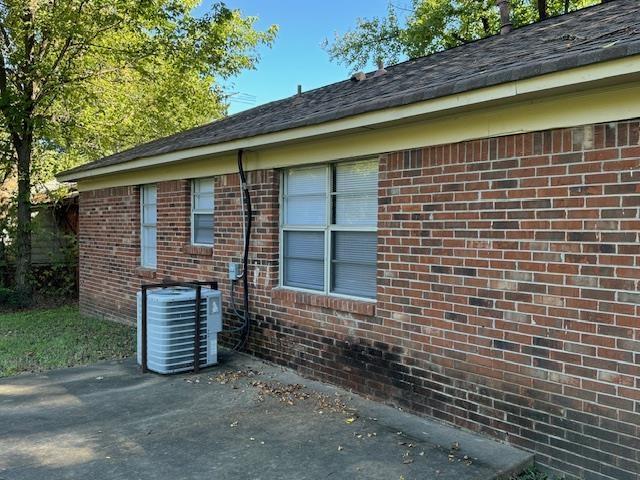 view of side of home featuring central AC and a patio area