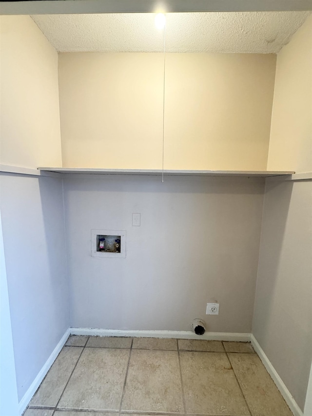 laundry area with hookup for an electric dryer, washer hookup, and a textured ceiling