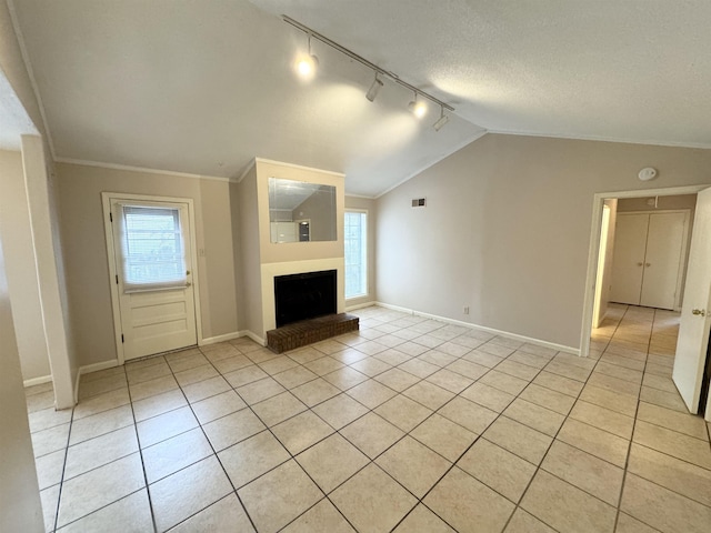 unfurnished living room featuring light tile patterned floors, crown molding, and a brick fireplace