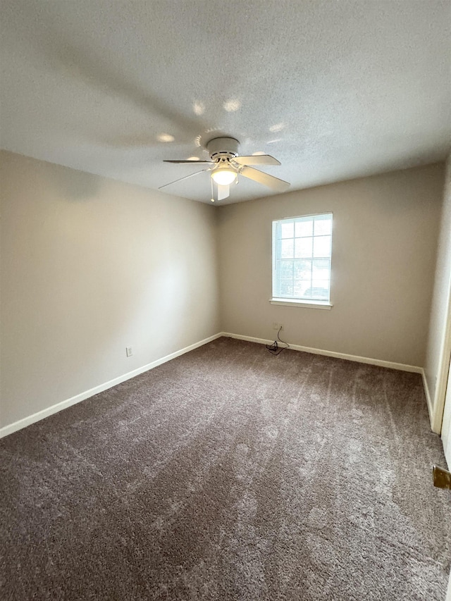 carpeted empty room featuring ceiling fan and a textured ceiling