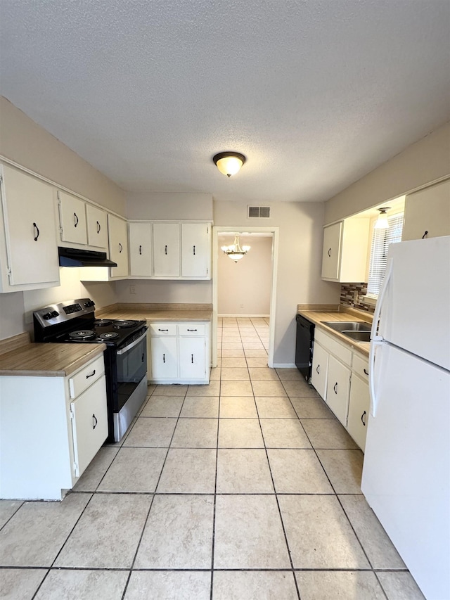 kitchen featuring white cabinets, sink, stainless steel range with electric cooktop, and white refrigerator