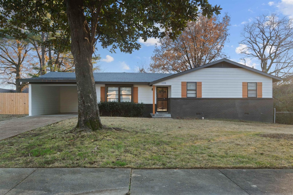 ranch-style home featuring a carport and a front yard