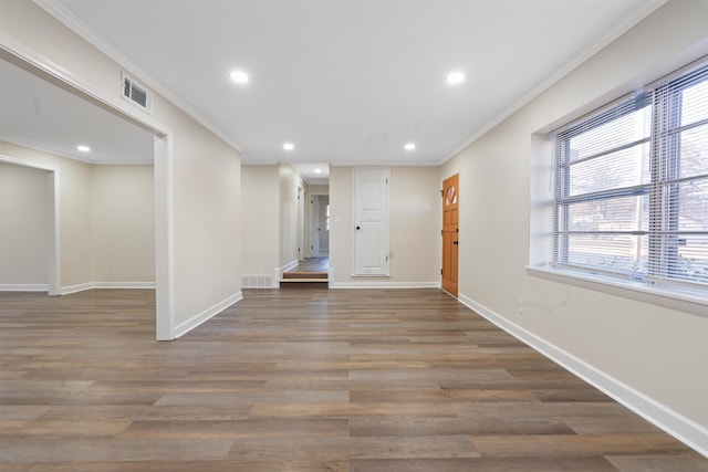 interior space featuring ornamental molding and dark wood-type flooring