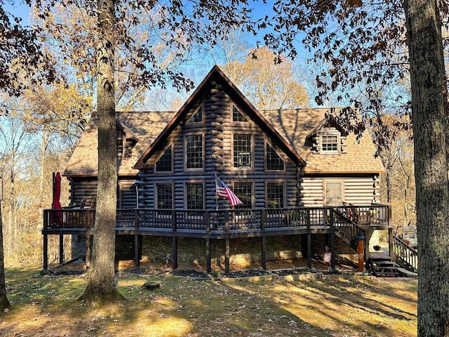 rear view of property featuring a deck