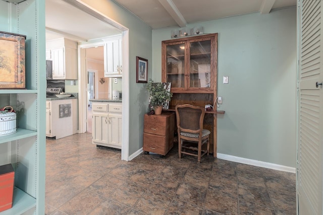 office area featuring beamed ceiling and washer / dryer