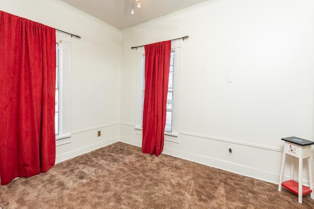 carpeted spare room featuring ceiling fan and ornamental molding