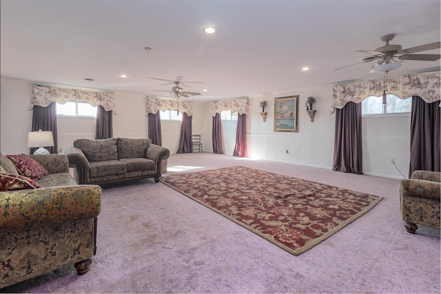 carpeted living room with ceiling fan