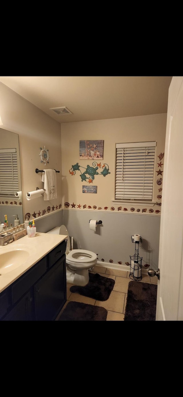 bathroom with tile patterned floors, vanity, and toilet