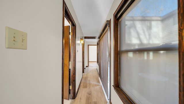 corridor with light wood-type flooring