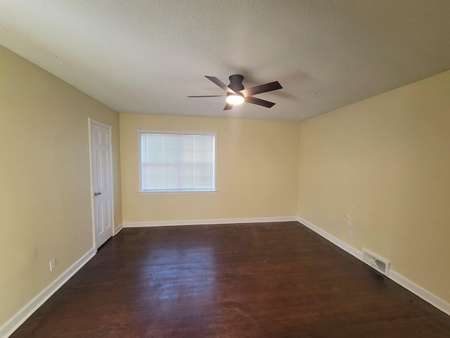 spare room with ceiling fan, dark hardwood / wood-style flooring, and a textured ceiling