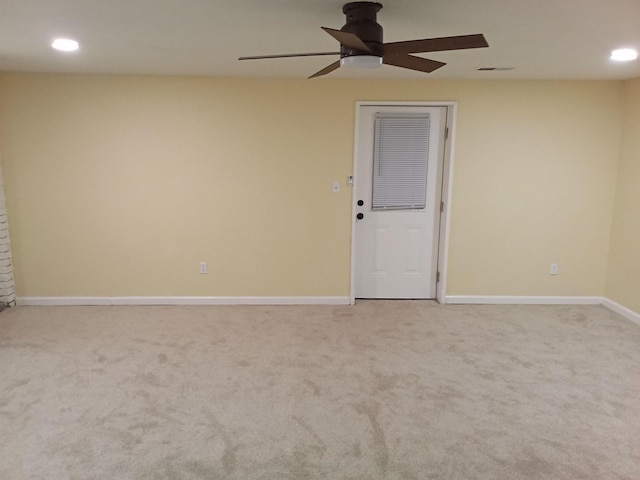 carpeted spare room with ceiling fan