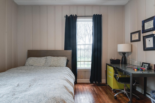 bedroom with multiple windows and dark hardwood / wood-style flooring