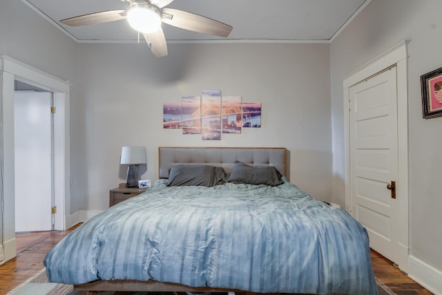 bedroom featuring wood-type flooring, ceiling fan, and ornamental molding