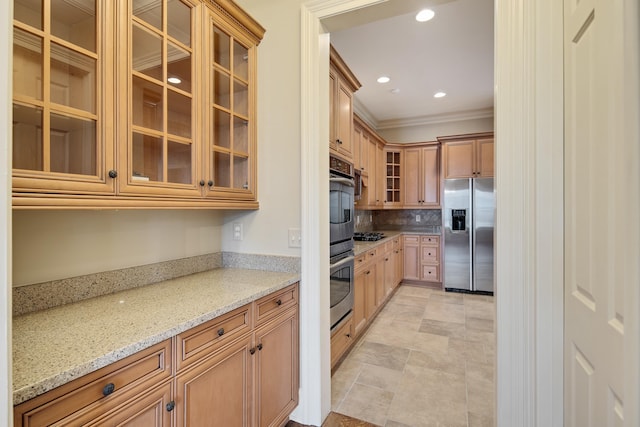 kitchen with backsplash, stainless steel appliances, light stone counters, and crown molding