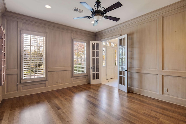 unfurnished room featuring french doors, dark hardwood / wood-style floors, a wealth of natural light, and ceiling fan