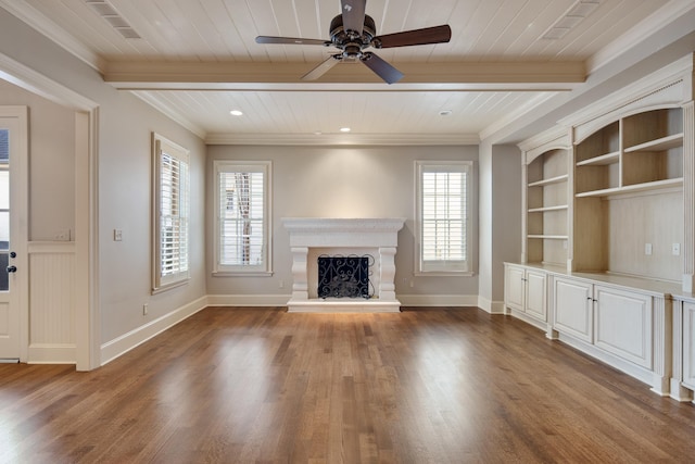 unfurnished living room featuring hardwood / wood-style flooring, ceiling fan, a wealth of natural light, and built in shelves