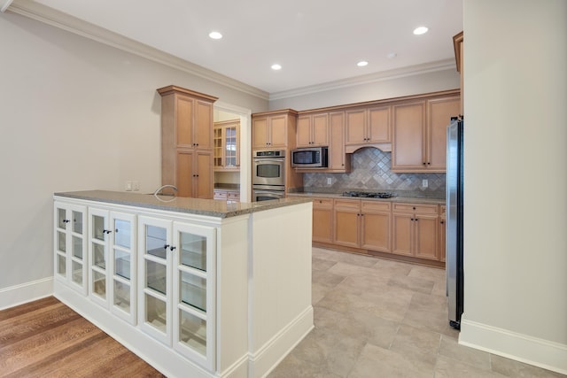 kitchen featuring decorative backsplash, appliances with stainless steel finishes, kitchen peninsula, light stone counters, and ornamental molding