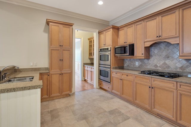 kitchen with sink, light stone counters, decorative backsplash, appliances with stainless steel finishes, and ornamental molding