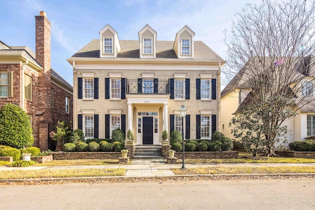 colonial home featuring a balcony