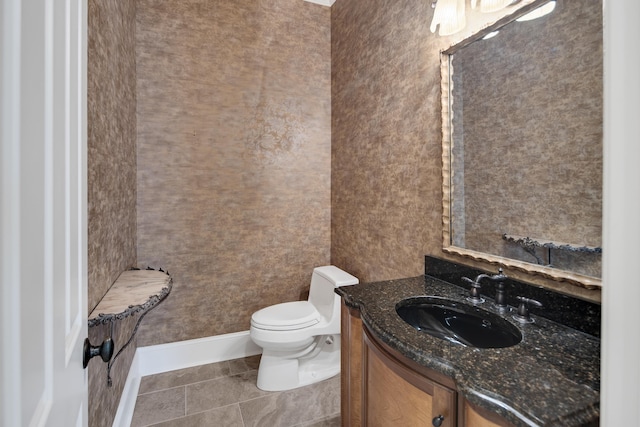 bathroom featuring tile patterned floors, vanity, and toilet