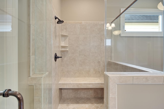 bathroom with tiled shower