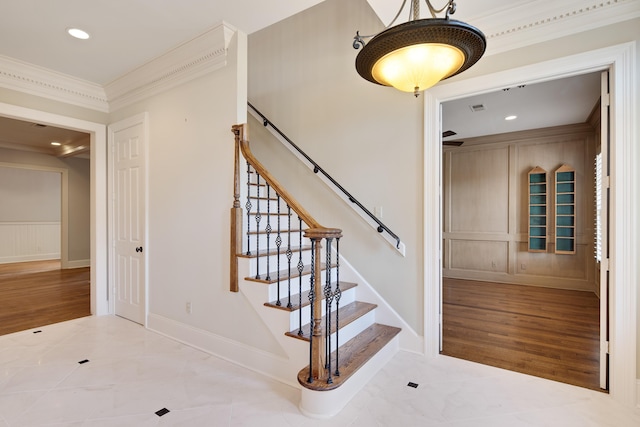 staircase featuring crown molding