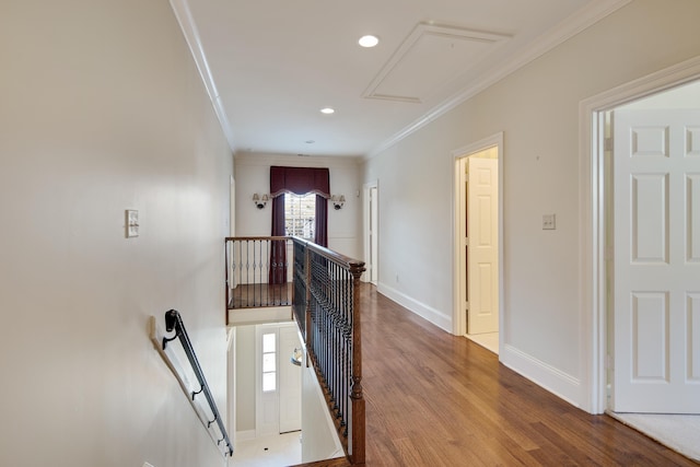 hallway with hardwood / wood-style flooring and ornamental molding