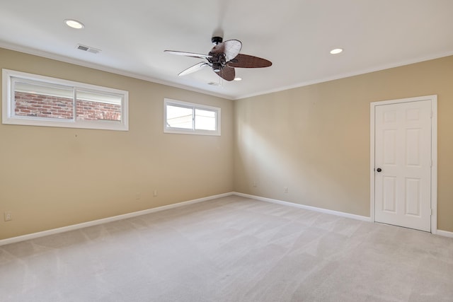 carpeted empty room with ceiling fan and crown molding