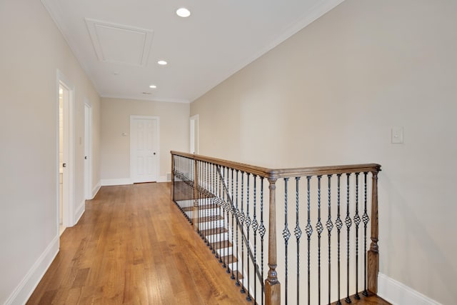 hallway featuring light wood-type flooring and ornamental molding