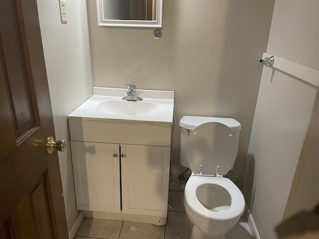 half bath featuring vanity, toilet, and tile patterned floors