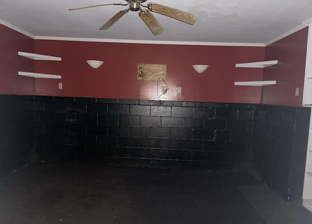 interior details featuring ornamental molding, wainscoting, and ceiling fan