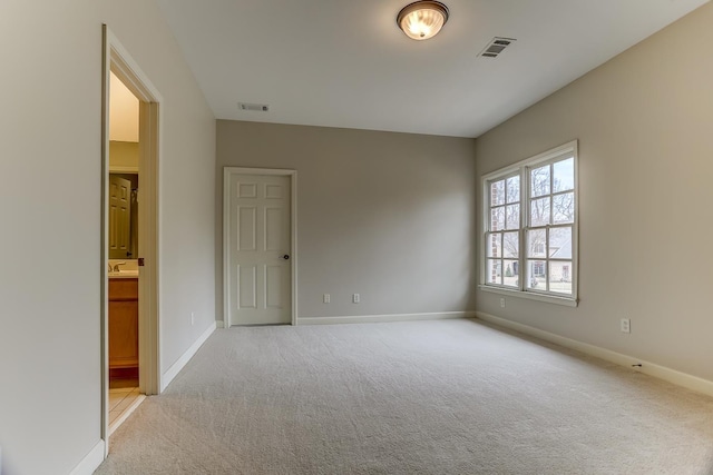 carpeted empty room featuring sink