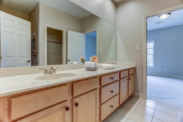 bathroom with tile patterned floors and vanity