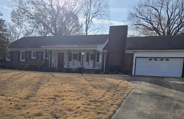 single story home featuring a porch and a garage