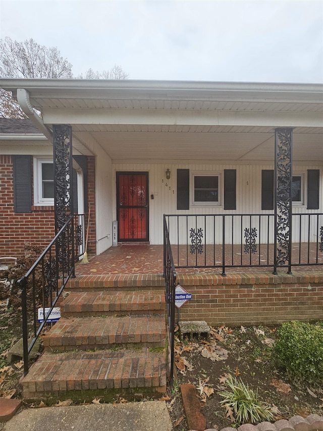 view of exterior entry featuring a porch