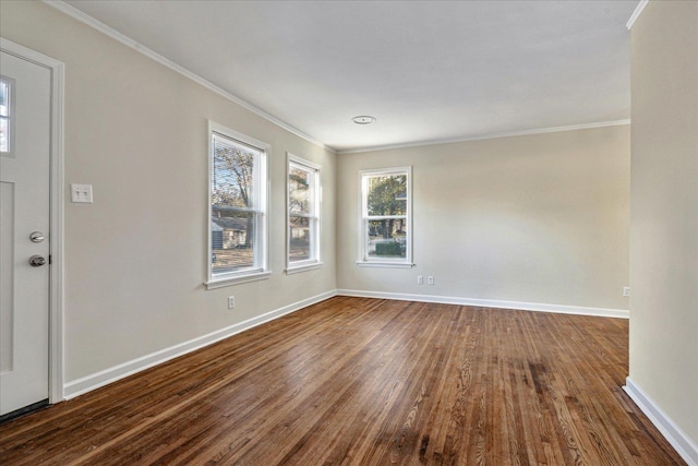 empty room featuring crown molding and dark hardwood / wood-style flooring