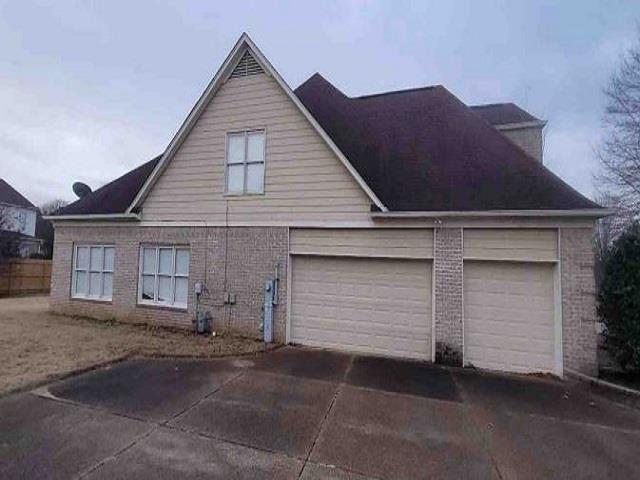 view of side of home with a garage