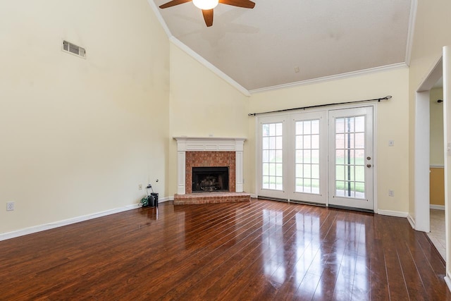 unfurnished living room with high vaulted ceiling, a brick fireplace, ceiling fan, and crown molding