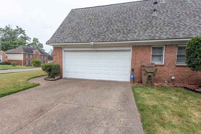 garage featuring a lawn