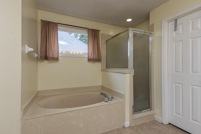 bathroom featuring shower with separate bathtub, a textured ceiling, and tile patterned floors