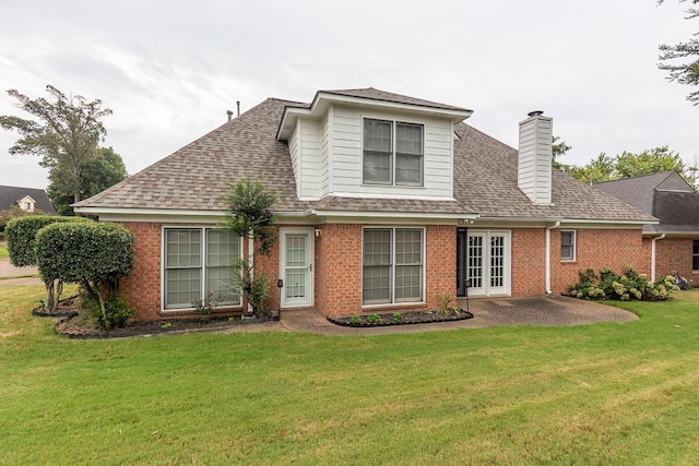 back of property featuring french doors, a patio, and a lawn