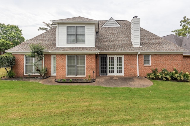 rear view of property with a lawn and a patio area